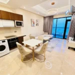 Fully furnished modern 1 bedroom apartment living area in Juffair with open sea view from a high floor