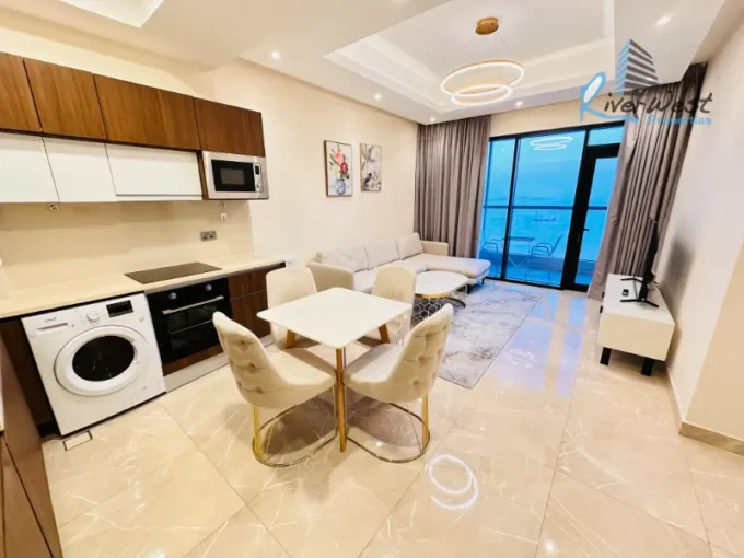 Fully furnished modern 1 bedroom apartment living area in Juffair with open sea view from a high floor