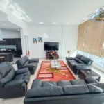 Fully furnished 2 bedroom apartment living and dining area in Juffair with high ceiling and full glass city view