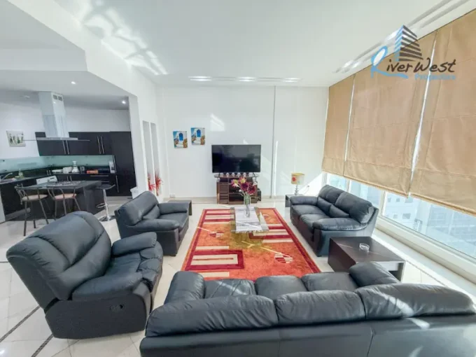 Fully furnished 2 bedroom apartment living and dining area in Juffair with high ceiling and full glass city view